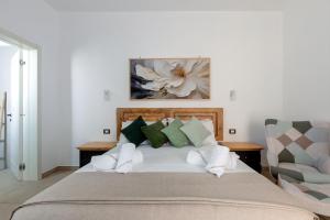 a bedroom with a bed and a chair at Domus Sagari in Presicce