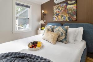 a room with a bed with a bowl of fruit on it at Harvard Charm Near Boston New build in Cambridge
