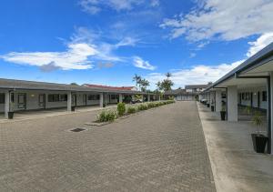 a row of buildings on a brick road at Alara Motor Inn in Mackay