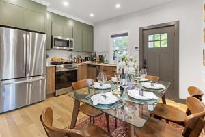 a kitchen with a table and chairs and a refrigerator at Harvard Charm Near Boston New build in Cambridge