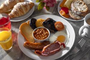 a plate of breakfast food with eggs sausage beans and bread at Best Western The Royal Chase Hotel in Shaftesbury