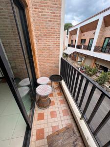a balcony with a table and chairs on a building at Maolao bar and hotel in Pai