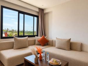 a living room with a couch and a large window at Oceana Mazagan Suites Hôtel in El Jadida
