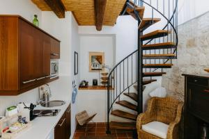 a kitchen with a spiral staircase and a sink at Casa.Peiso in Mörbisch am See