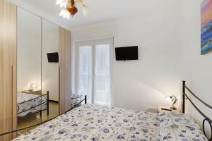 a bedroom with a bed and a tv on the wall at Casa Antonio in Alassio