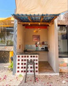 an outdoor kitchen with a bar in a house at Habitación, balcón frente al mar y alberca in Lerma