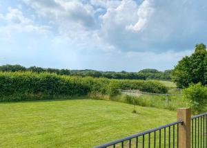 a view of a yard with a fence at Oak Farm Lodges in Roydon +33 photos
