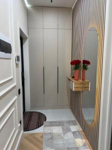 a hallway with a mirror and a dressing room at Жк Prime Park 2 in Shymkent