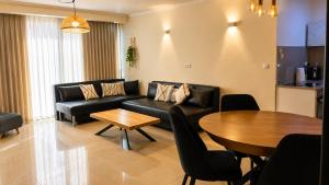 a living room with a couch and a table at Milano Suite in Lev Eilat in Eilat