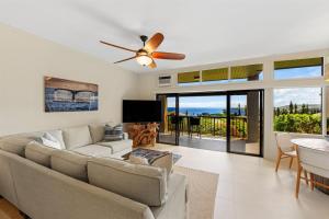 a living room with a couch and a ceiling fan at 1712 Kapalua Home in Kahana