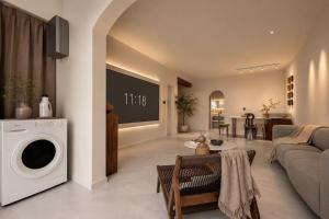 a living room with a couch and a washer and dryer at Lucky Designer Residence Near Bell Tower & City Wall in Xi'an