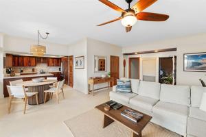 a living room with a couch and a table at 1712 Kapalua Home in Kahana +32 photos
