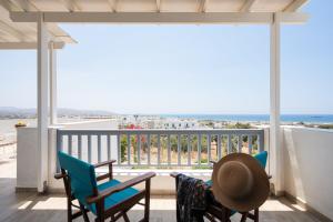 a balcony with chairs and a view of the ocean at Passa Corda Villa in Agios Prokopios