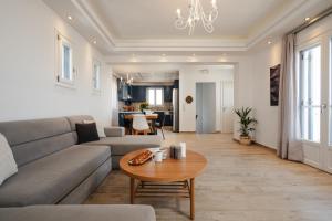 a living room with a couch and a table at Passa Corda Villa in Agios Prokopios