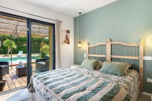 a bedroom with a bed and a large window at Villa Lailléa avec piscine jacuzzi in Laillé +37 photos