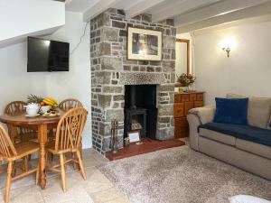 a living room with a couch and a fireplace at Small Barn - Uk52140 in Liskeard
