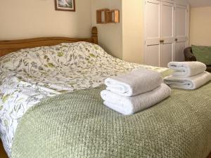 a bedroom with a bed with towels on it at Henwood Barn - Uk52138 in Liskeard