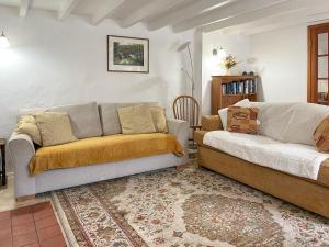 a living room with two couches and a rug at Henwood Barn - Uk52138 in Liskeard