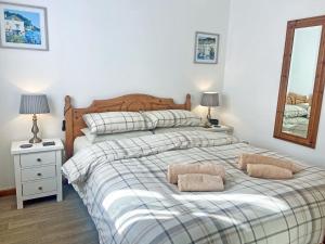 a bedroom with a bed with two pillows on it at Summer Breeze in St Austell