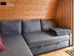 a gray couch in a room with a wooden wall at Selker View-Uk1397 in Corney