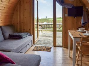 a living room with a couch and a table and a balcony at Selker View-Uk1397 in Corney