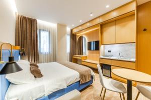 a hotel room with a bed and a table and a sink at Arbo Boutique Hotel in Durrës