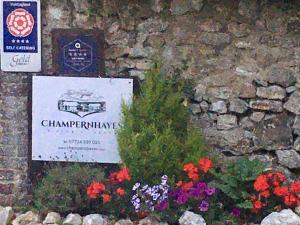 a sign on the side of a stone wall with flowers at Lark - Ukc6105 in Wootton Fitzpaine