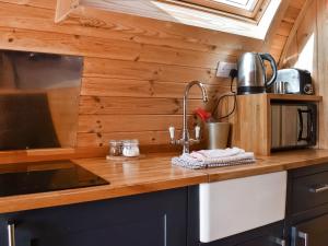 a kitchen with a sink and a counter top at Manx View-Uk1396 in Corney