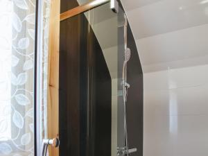 a shower with a glass door in a bathroom at Manx View-Uk1396 in Corney +6 photos