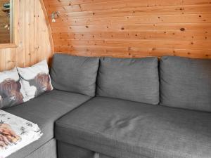a gray couch in a room with wooden walls at Black Coombe-Uk1392 in Corney