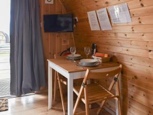 a wooden table with chairs and wine glasses on it at Black Coombe-Uk1392 in Corney