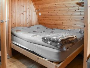 a bed in a wooden room with a wooden wall at Black Coombe-Uk1392 in Corney