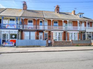 a large red brick house on the side of the street at Beachcombers Retreat in Felixstowe