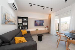 a living room with a couch and a table at Smash A - Apartments with Private Pool in Novalja