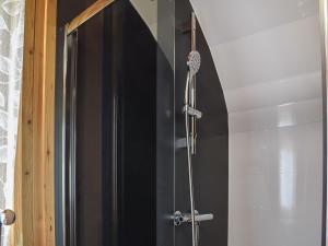 a shower in a bathroom with a black door at Withy Bottom-Uk1393 in Corney +7 photos