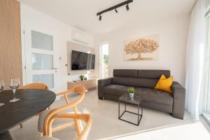 a living room with a couch and a table at Smash A - Apartments with Private Pool in Novalja