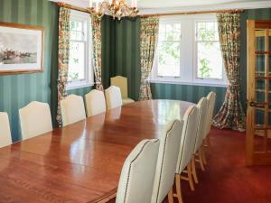 a dining room with a wooden table and chairs at Hall Teasses Lodge - Uk52175 in Leven