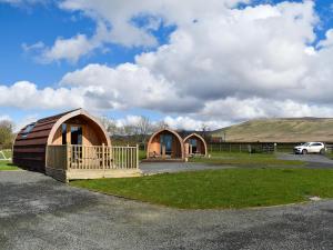 a couple of small huts in a parking lot at Barn Scar-Uk1394 in Corney
