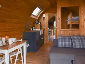 a living room with a couch and a table at Barn Scar-Uk1394 in Corney