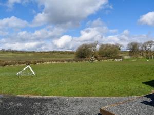 a grassy field with a white object in the grass at Barn Scar-Uk1394 in Corney +6 photos