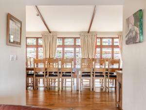 a dining room with a table and chairs and windows at The Cider Barn - Hggl in Luton +42 photos