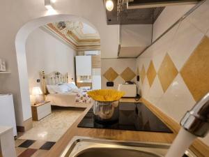 a kitchen with a sink and a room with a bed at Antica Dimora Donna Emma in Carini
