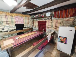 a small room with a bench and a refrigerator at Мехса in Svetoslav