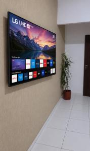 a flat screen tv hanging on a wall at Entire house in Mococa