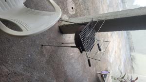 a bathroom with a toilet and a chair on the floor at Entire house in Mococa
