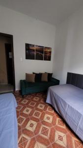 a living room with two beds and a couch at Entire house in Mococa