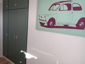 a picture of a white van hanging on a wall at Haus Schildt, FeWo 3 in Duhnen