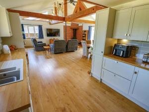 a kitchen and living room with wooden floors and a living room at 80 Pentney Lakes in King's Lynn