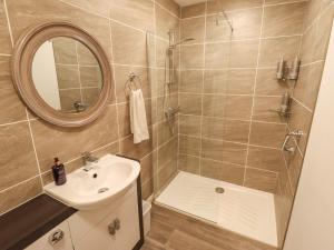 a bathroom with a shower and a sink and a mirror at 80 Pentney Lakes in King's Lynn +23 photos
