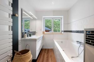 a white bathroom with a tub and a sink at Chalet Villarenger in Saint-Martin-de-Belleville +33 photos